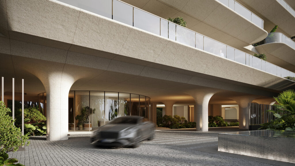 Entrance of Tyrian Residences with dual entry checkpoint, curved concrete pillars and soft lighting, offering secure and elegant arrival in Estepona.